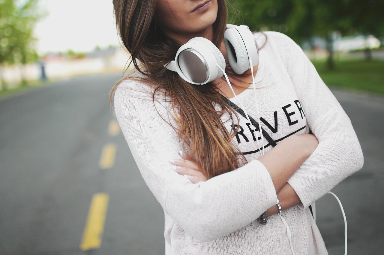 Woman listening to an audiobook with headphones on her commute using Audible app